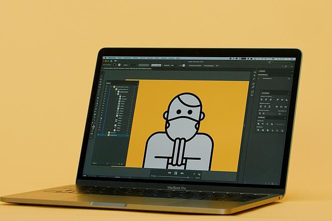 Ein Macbook Pro vor orangem Hintergrund, auf dem in Adobe Illustrator eine gezeichnete Person mit Maske betend abgebildet ist.